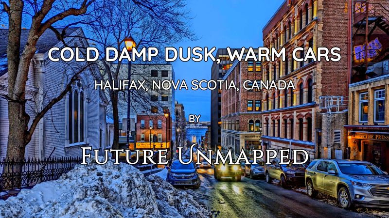 Cars navigate street incline - away from city waterfront - with headlights reflecting off wet road, passing ever-growing snowbank outside 275-year-old church.